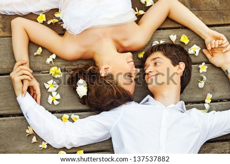 newlyweds on the floor (soft focus on the bride\'s eyes)