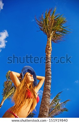 summer holidays concept - woman under the exotic palm tree
