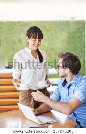 situation in office - woman sharing tea with man