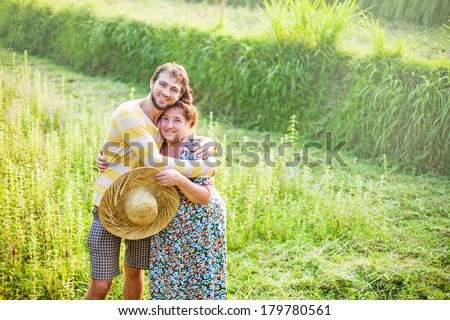 son with his mother at the field