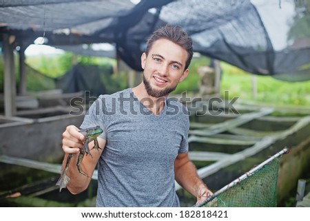 Farmer in frog farm in Bali