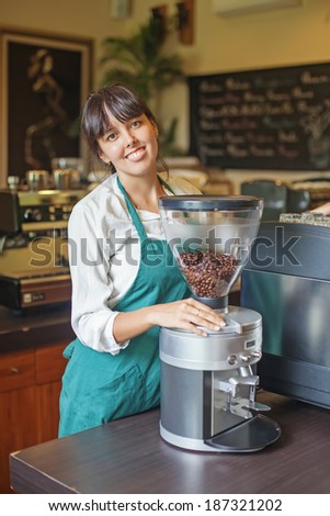Woman working in restaurant and making coffee