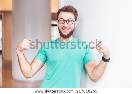 man pointing at his t-shirt (can be used as a clothes design template)