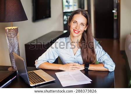 friendly self-employed female lawyer sitting in her office
