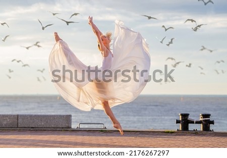 Similar – Image, Stock Photo Young slim ballerina jumping above ground in studio flexing legs.