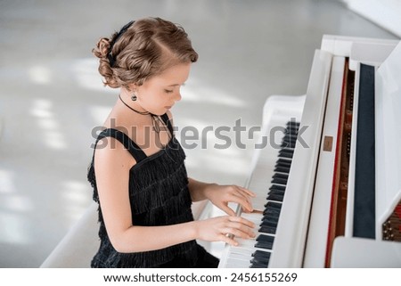 Image, Stock Photo Smiling child playing piano in cozy room in daylight