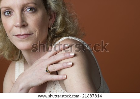 Portrait of a 50-year old woman on a plain background