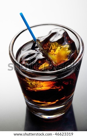 Black Russian mixed drink on a grey background with reflection