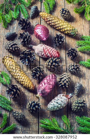 toys for the Christmas tree and pine cones on old wooden background.Christmas. Christmas time. Pine cones   Wooden background. toning