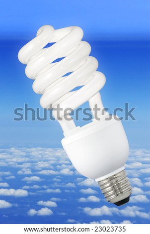 Low-energy light bulb over a blue sky background above the clouds
