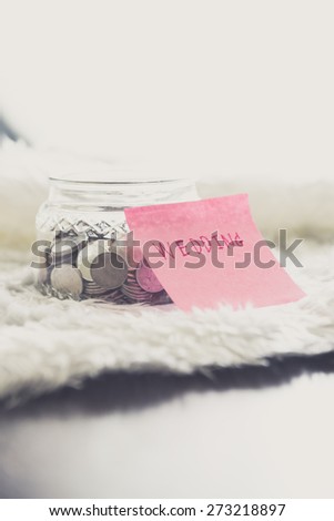 many coins in a money jar with wedding label on jar. wedding concept. saving concept