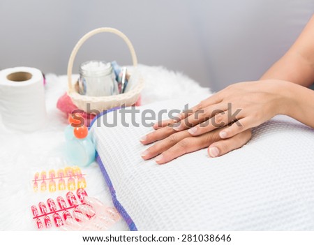 Woman in a nail salon and nail art receiving a manicure