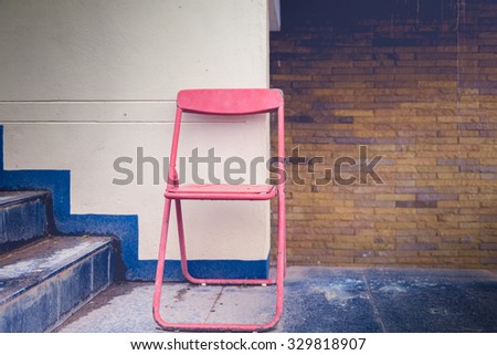 Vintage folding chair and old walls. vintage tone color