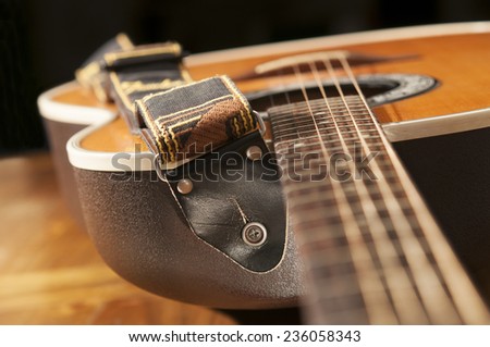 Classic guitar detail with strap.
