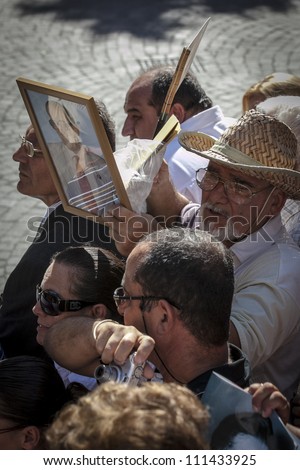 VALLETTA, MALTA - AUG 25 - A man hold up a framed picture during the state funeral of former Prime Minister of Malta Dom Mintoff in Valletta on 25 August 2012