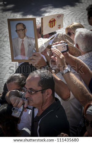 VALLETTA, MALTA - AUG 25 - A man hold up a framed picture during the state funeral of former Prime Minister of Malta Dom Mintoff in Valletta on 25 August 2012