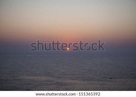 The sun rises over the calm waters of the Mediterranean Sea in Malta