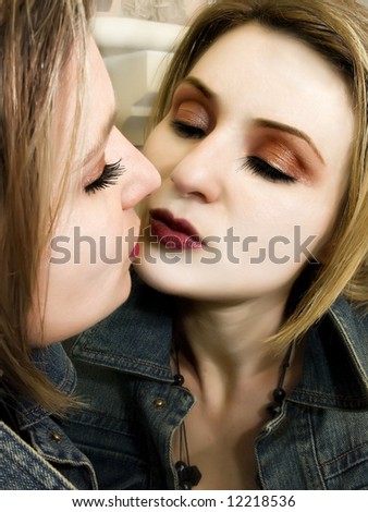 Two beautiful women giving their first kiss to each other