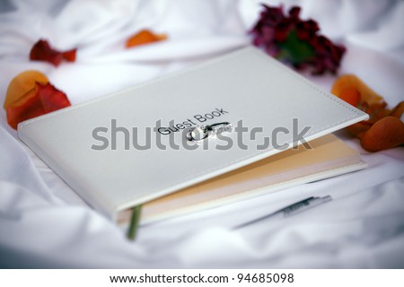 Wedding guest book on a white silk tablecloth