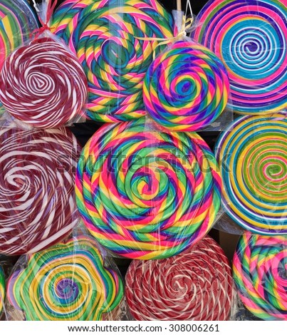 Hard candy  popsicles background made of different colors and spiral shapes in Mexican street market