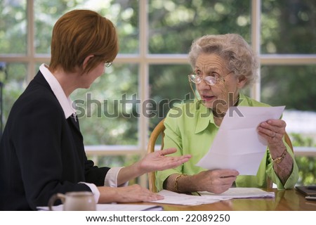 Mature woman talking to financial planner at home