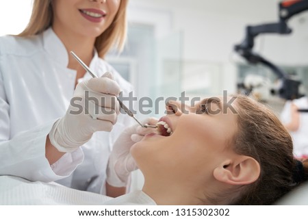 Similar – Image, Stock Photo Dentist treating teeth of patient with UV light