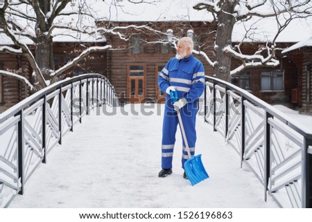 Foto Bild Mann räumt im Winter mit einer Schneefräse den Schnee beiseite