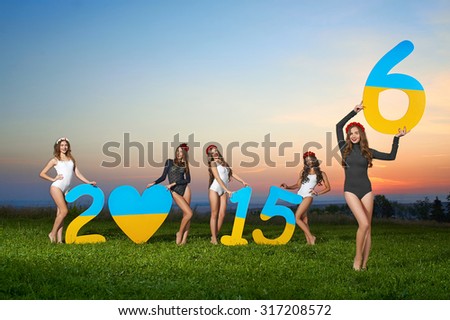 2016 year, composition, shadows, silhouettes of five sexy girls, models hold the 2016 figures; in open areas against the background of sunset and blue sky.