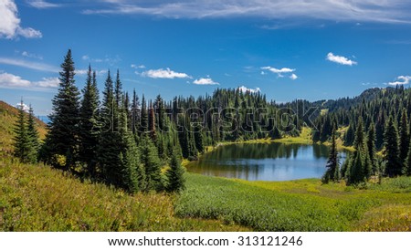Tod Lake under a beautiful sky on a hike to the summit of Tod Mountain in the Sushwap Highlands of central British Columbia, Canada. The lake is at an elevation of about 6000 feet