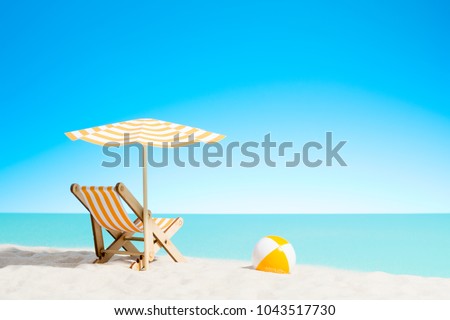 Similar – Image, Stock Photo Sunshade and deck chairs on a beach in Mauritius