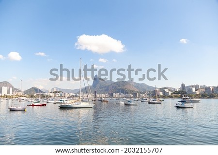 Beautiful view of a sunny morning in Urca, Rio de Janeiro, from where you can see a blue sky, the bay, colorful boats, reflections, hills, city buildings, and Christ the Redeemer. Imagine de stoc © 