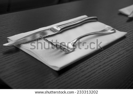 Cutlery knife and fork on napkin. Indoor shot using natural light.