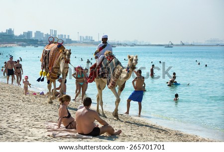 JUMEIRAH BEACH,UNITED ARAB EMIRATES-DECEMBER 6, 2013: Relaxing people on Jumeirah beach in Dubai,United Arab Emirates