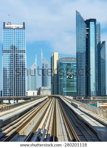 DUBAI,UNITED ARAB EMIRATES-DECEMBER 5, 2013: Skycrapers in modern centre of Dubai with metro railways,Dubai,United Arab Emirates