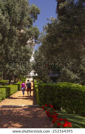 Haifa,Israel - May 24,2014:Young couple walking by the path of tropical garden in Haifa,Israel