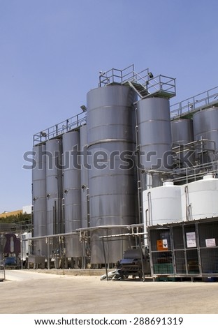 Wine making vats and contemporary equipment in tour of winery with steel barrels