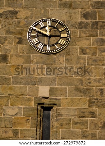 clock on tower wall at All Saints Church, Ashover village, derbyshire,UK . taken 22/03/2015