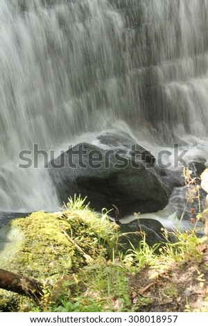 Cascading water from Rouken Glen Park Waterfall - Glasgow - Scotland