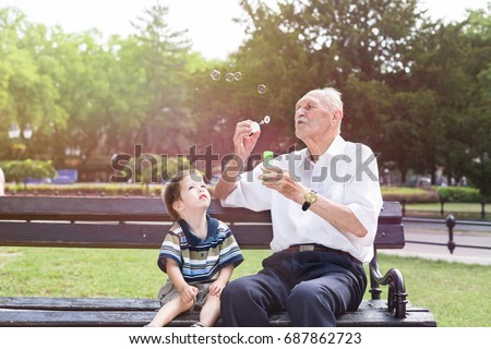 Similar – Image, Stock Photo Grandpa and grandson sitting on a bench in the forest