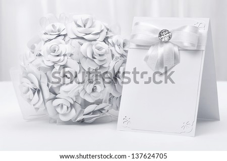 Bouquet of white roses with a card on a white background