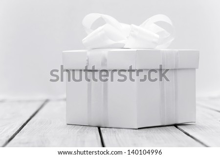 White box with a gift in a stylized white