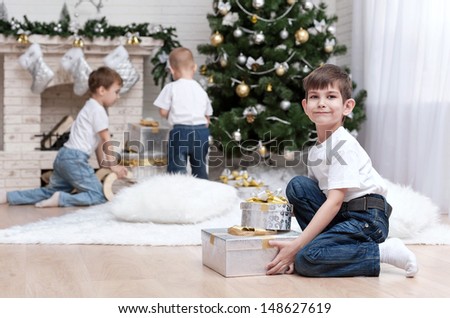 Children make out gifts at Christmas tree