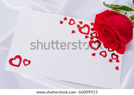 Red rose with the invitation to a white background