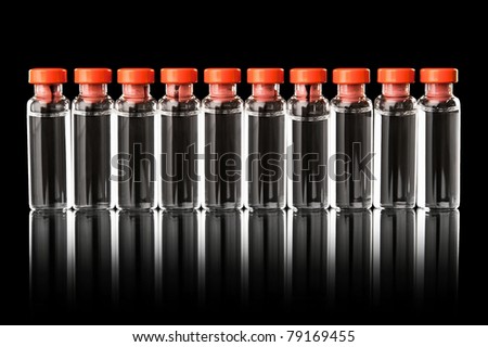 Medical bottles in the row isolated on black