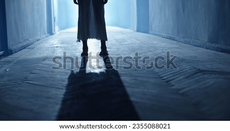 Low angle shot of legs of little girl ghost slowly creeping on floor of hallway of old abandoned haunted house - horror scene, horror movie  Foto stock © 