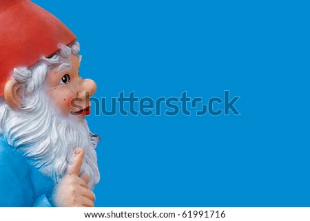 garden gnome with a wagging finger isolated on blue