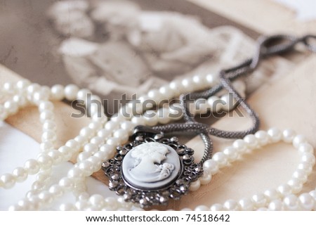 victorian cameo and pearl necklace in front of vintage picture