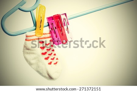 Colorful socks hanging on the clothesline. Image on white background with vignette ,vintage style
