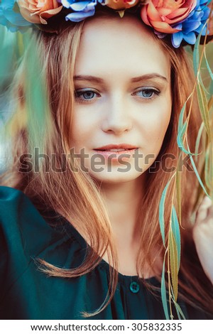 A portrait of a young lady with red hair in the evening sunset lights. Portrait with warm colors.