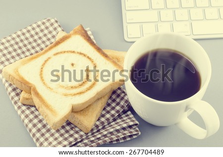 Morning coffee and toasted bread with smiling burn mark